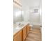 Bright bathroom featuring a single sink vanity, wood cabinets, and a shower over tub combination at 7936 Pinnochio Ave, Las Vegas, NV 89131