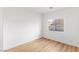 Light-filled bedroom with wood-style flooring and a large window at 7936 Pinnochio Ave, Las Vegas, NV 89131