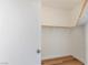 Walk-in closet with a wooden rod for hanging clothes and wood-style flooring at 7936 Pinnochio Ave, Las Vegas, NV 89131