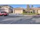 Charming single-story house with a two-car garage, green lawn, and drought resistant landscaping at 7936 Pinnochio Ave, Las Vegas, NV 89131
