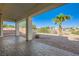 Covered patio area overlooking a xeriscaped backyard with a palm tree and block wall at 8305 Chapelle Ct, Las Vegas, NV 89131