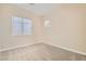 Bright bedroom featuring neutral walls, plush carpet, and a window bringing in natural light at 8305 Chapelle Ct, Las Vegas, NV 89131