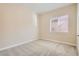 Neutral bedroom with beige carpet, light walls, and a window for natural light at 8305 Chapelle Ct, Las Vegas, NV 89131