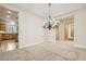 Elegant dining room featuring a chandelier and seamless flow into the kitchen and hallway at 8305 Chapelle Ct, Las Vegas, NV 89131