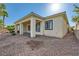 Back exterior of a home featuring a covered patio and low maintenance landscaping at 8305 Chapelle Ct, Las Vegas, NV 89131