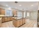 Bright kitchen with granite countertops, an island, and open layout adjacent to the carpeted living area at 8305 Chapelle Ct, Las Vegas, NV 89131