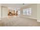 Open-concept living space seamlessly connects the kitchen and living room, featuring plush carpeting at 8305 Chapelle Ct, Las Vegas, NV 89131
