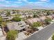 Wide aerial view of a single-story brick home with a mountain view and community landscaping at 8504 Mystic Night Ave, Las Vegas, NV 89143