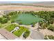 Expansive aerial view featuring a serene pond, lush greenery and distant mountains in a tranquil landscape at 8504 Mystic Night Ave, Las Vegas, NV 89143
