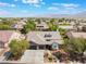 Spacious aerial view of a single-story brick home with manicured landscaping and a desert mountain view at 8504 Mystic Night Ave, Las Vegas, NV 89143