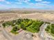 Panoramic aerial view showcasing diverse buildings, green spaces, and expansive desert landscape with distant mountains at 8504 Mystic Night Ave, Las Vegas, NV 89143