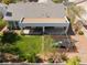 Aerial view of the backyard with covered patio, manicured lawn, and play area at 8504 Mystic Night Ave, Las Vegas, NV 89143