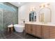 Spa-like bathroom features dual sinks, modern mirrors, and a luxurious soaking tub at 8504 Mystic Night Ave, Las Vegas, NV 89143