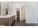 Bright bathroom with dual sinks, modern fixtures, and walk-in closet access at 8504 Mystic Night Ave, Las Vegas, NV 89143