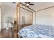 Bright bedroom featuring a four-poster bed, rocking chair, and plenty of natural light at 8504 Mystic Night Ave, Las Vegas, NV 89143