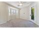 Bright bedroom with carpet, window with shutters and a door to the outdoor patio at 8504 Mystic Night Ave, Las Vegas, NV 89143