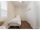Bright bedroom featuring a twin bed, dark wood floors, and a window with white shutters at 8504 Mystic Night Ave, Las Vegas, NV 89143