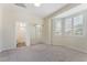 Spacious bedroom with carpet, mirrored closet and a window with shutters at 8504 Mystic Night Ave, Las Vegas, NV 89143
