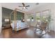 Charming bedroom with a four-poster bed, rocking chair, and access to the backyard at 8504 Mystic Night Ave, Las Vegas, NV 89143