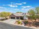 Charming single-story brick home boasts a three-car garage, dormer windows and manicured landscaping at 8504 Mystic Night Ave, Las Vegas, NV 89143
