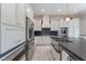 Close up of a bright kitchen with a large island and a stainless steel farmhouse sink with gold faucet at 8504 Mystic Night Ave, Las Vegas, NV 89143