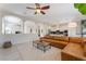 Open-concept living room featuring a leather sofa, modern decor, and a seamless flow to the adjacent kitchen at 8504 Mystic Night Ave, Las Vegas, NV 89143