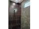 Contemporary shower with black tile, rainfall showerhead, handheld sprayer, and built-in bench seating at 8504 Mystic Night Ave, Las Vegas, NV 89143