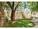 Picturesque backyard featuring a tree swing, lush grass, and a charming garden at 8873 Briar Bay Dr, Las Vegas, NV 89131