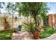Tranquil backyard featuring desert landscaping, stone patio, and mature tree providing ample shade at 8873 Briar Bay Dr, Las Vegas, NV 89131