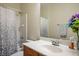 Bathroom with shower and tub, and a sink with a wood cabinet at 8873 Briar Bay Dr, Las Vegas, NV 89131