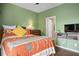 Comfortable bedroom with hardwood floors, colorful quilt, and a wall-mounted entertainment center at 8873 Briar Bay Dr, Las Vegas, NV 89131