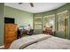 Bedroom with a work space, a TV, windows offering natural light, and comfortable furniture at 8873 Briar Bay Dr, Las Vegas, NV 89131
