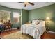 Comfortable bedroom with a ceiling fan, a vintage desk area, and natural light from the window at 8873 Briar Bay Dr, Las Vegas, NV 89131