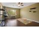 Spacious bedroom with dark wood floors, ceiling fan, and a hanging chair at 8873 Briar Bay Dr, Las Vegas, NV 89131