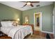 Cozy bedroom featuring natural light, olive green walls, and a door leading to a walk-in closet at 8873 Briar Bay Dr, Las Vegas, NV 89131