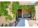 Welcoming covered porch with climbing vines, seating, and decorative pots at 8873 Briar Bay Dr, Las Vegas, NV 89131