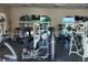 Bright fitness center with modern equipment, large arched windows, and view of the community pool at 8873 Briar Bay Dr, Las Vegas, NV 89131