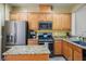 Granite countertops, stainless appliances, and ample cabinets provide functionality with style in this well-designed kitchen at 8873 Briar Bay Dr, Las Vegas, NV 89131