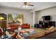 Inviting living room featuring comfortable seating, neutral paint, a ceiling fan, and a view of the backyard at 8873 Briar Bay Dr, Las Vegas, NV 89131