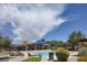 Community pool with seating, shade umbrellas, and well-maintained landscaping, perfect for relaxation at 8873 Briar Bay Dr, Las Vegas, NV 89131