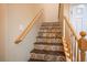 Staircase featuring custom-designed tile risers, a wooden handrail, and a neutral wall color at 8873 Briar Bay Dr, Las Vegas, NV 89131