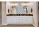 Bathroom vanity featuring double sinks, undermount sinks, framed mirrors, and modern light fixtures at 9328 Jumpin Juniper Ave, Las Vegas, NV 89129