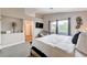 View of the main bedroom with natural light, a wall-mounted TV, and neutral decor at 9328 Jumpin Juniper Ave, Las Vegas, NV 89129