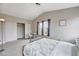 Cozy bedroom with neutral tones, a large closet, and a desk by the window at 9328 Jumpin Juniper Ave, Las Vegas, NV 89129