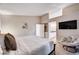 Spacious main bedroom with a large bed, cozy chair, and access to the bathroom at 9328 Jumpin Juniper Ave, Las Vegas, NV 89129