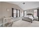 Large bedroom featuring multiple windows and a decorative accent wall at 9328 Jumpin Juniper Ave, Las Vegas, NV 89129