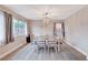 Bright dining room features stylish light fixture, wood floors, and a dining table that seats six at 9328 Jumpin Juniper Ave, Las Vegas, NV 89129