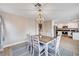 Bright dining room features modern chandelier, neutral paint, and an entry to the kitchen at 9328 Jumpin Juniper Ave, Las Vegas, NV 89129