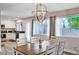Bright dining room features modern chandelier, neutral paint, and an open floorplan at 9328 Jumpin Juniper Ave, Las Vegas, NV 89129