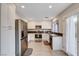 Modern kitchen with stainless steel appliances, white cabinetry, and a door leading to the backyard at 9328 Jumpin Juniper Ave, Las Vegas, NV 89129